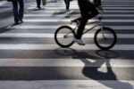 Pedestrian and cyclist crossing the crosswalk at Avenida Paulista. Image shot 08/2011. Exact date unknown.